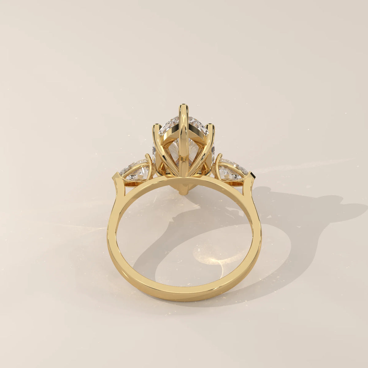 Umor 5 Carat Marquise Lab Grown Diamond Three Stone Ring, Pear Sides in yellow gold, side profile view.