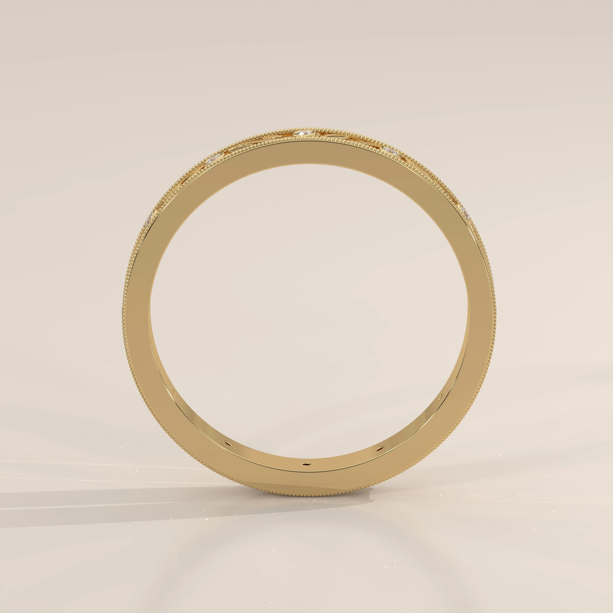 Vintage Engraved Band with Bezel Set Diamond Stations in yellow gold, front view on a plain background.